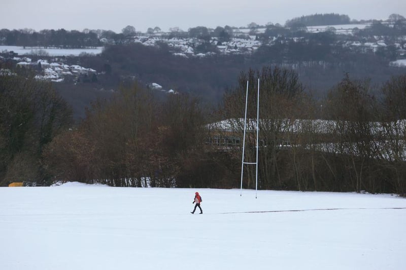 A person makes their way across the snow covered grounds of Sheffield, in northern England.