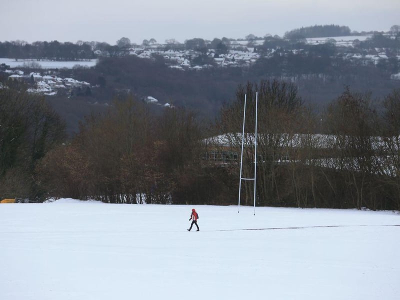 A person makes their way across the snow covered grounds of Sheffield, in northern England.