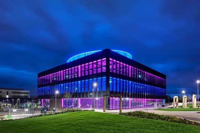 A view of the Halo HQ building in Kilmarnock lit up at night.
