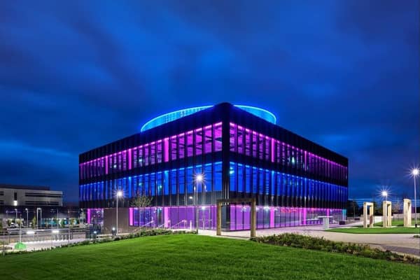 A view of the Halo HQ building in Kilmarnock lit up at night.