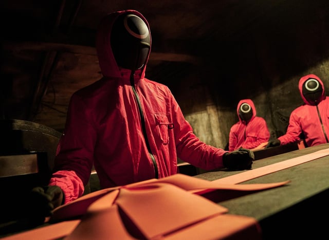 The red-clad guards enforce the rules of the playground games with brutal violence. Photo: Netflix.