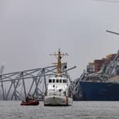 The US Coast Guard works at the scene after the cargo ship Dali collided with the Francis Scott Key Bridge causing it to collapse (Photo by Scott Olson/Getty Images)