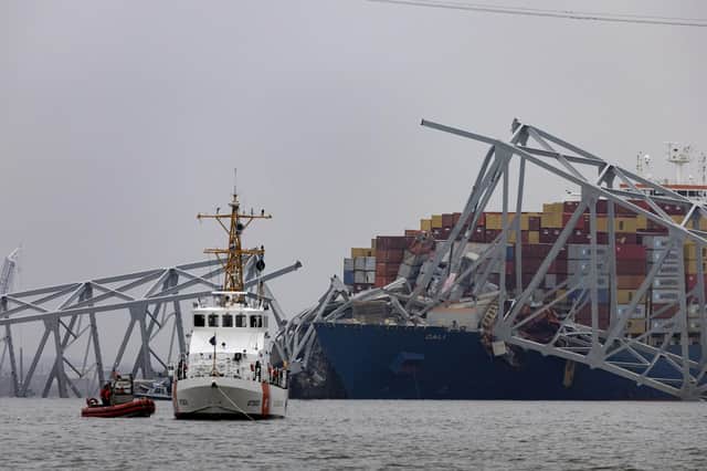 The US Coast Guard works at the scene after the cargo ship Dali collided with the Francis Scott Key Bridge causing it to collapse (Photo by Scott Olson/Getty Images)