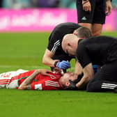 Wales' Neco Williams receiving treatment for an injury. Robert Page has defended the decision to let Williams play on after the Wales full-back suffered a head injury against England at the World Cup. Issue date: Wednesday November 30, 2022.