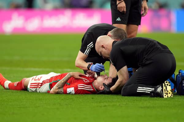 Wales' Neco Williams receiving treatment for an injury. Robert Page has defended the decision to let Williams play on after the Wales full-back suffered a head injury against England at the World Cup. Issue date: Wednesday November 30, 2022.