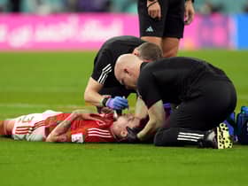 Wales' Neco Williams receiving treatment for an injury. Robert Page has defended the decision to let Williams play on after the Wales full-back suffered a head injury against England at the World Cup. Issue date: Wednesday November 30, 2022.
