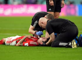 Wales' Neco Williams receiving treatment for an injury. Robert Page has defended the decision to let Williams play on after the Wales full-back suffered a head injury against England at the World Cup. Issue date: Wednesday November 30, 2022.