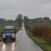 A police van patrols the roads around the blast site