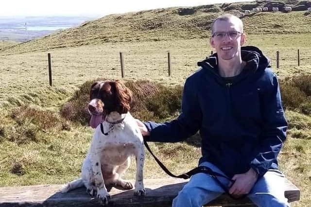 Andrew Moss and his dog near his home in Fife