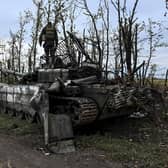A Ukrainian soldier stands on top of an abandoned Russian tank near a village on the outskirts of Izyum, Kharkiv region, eastern Ukraine (Picture: Juan Barreto/AFP via Getty Images)