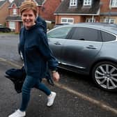 Nicola Sturgeon smiles as she arrives at her home following her resignation as Scotland’s First Minister (Picture: Jeff J Mitchell/Getty Images)