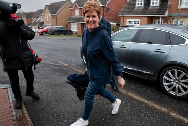 Nicola Sturgeon smiles as she arrives at her home following her resignation as Scotland’s First Minister (Picture: Jeff J Mitchell/Getty Images)
