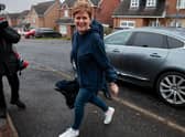 Nicola Sturgeon smiles as she arrives at her home following her resignation as Scotland’s First Minister (Picture: Jeff J Mitchell/Getty Images)