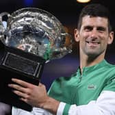 Serbia's Novak Djokovic holds the Norman Brookes Challenge Cup after defeating Russia's Daniil Medvedev in the men's singles final at the Australian Open tennis championship in Melbourne, Australia, Sunday, Feb. 21, 2021. Djokovic has had his visa canceled and been denied entry to Australia. (AP Photo/Andy Brownbill, File)