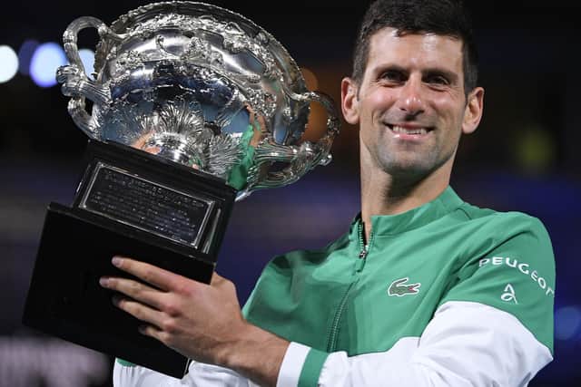 Serbia's Novak Djokovic holds the Norman Brookes Challenge Cup after defeating Russia's Daniil Medvedev in the men's singles final at the Australian Open tennis championship in Melbourne, Australia, Sunday, Feb. 21, 2021. Djokovic has had his visa canceled and been denied entry to Australia. (AP Photo/Andy Brownbill, File)
