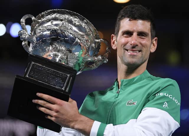 Serbia's Novak Djokovic holds the Norman Brookes Challenge Cup after defeating Russia's Daniil Medvedev in the men's singles final at the Australian Open tennis championship in Melbourne, Australia, Sunday, Feb. 21, 2021. Djokovic has had his visa canceled and been denied entry to Australia. (AP Photo/Andy Brownbill, File)