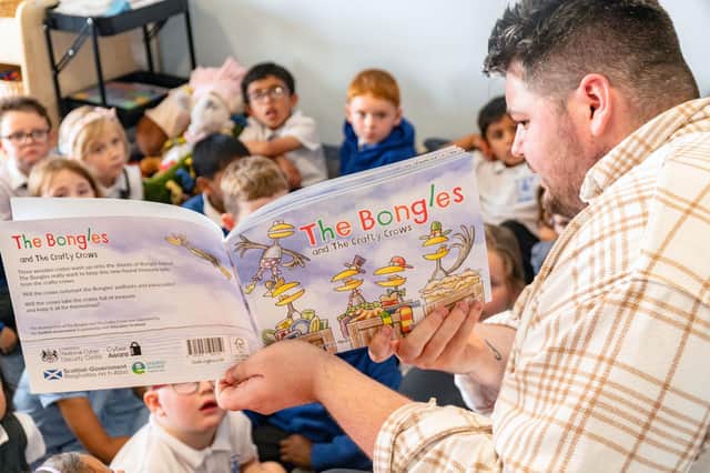 A Our Lady's RC Primary School teacher reading The Bongles and The Crafty Crows.  Photo: Abertay University/PA Wire