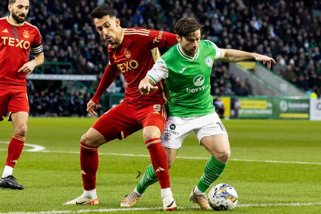 Hibs left-back Lewis Stevenson challenges Aberdeen's Bojan Miovski during the 2-0 win at Easter Road on Sunday. (Photo by Ross Parker / SNS Group)