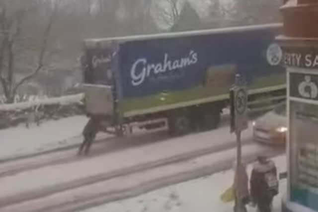 Outstanding video shows the moment an optimistic woman helps push a lorry up an icy hill in Fife.
