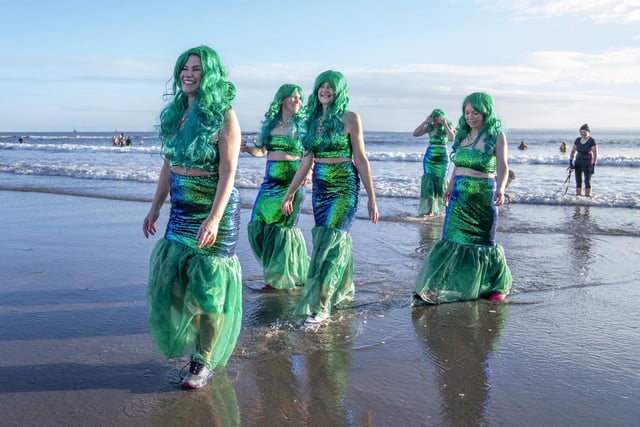People take part in a Loony Dook New Year's Day dip in the Firth of Forth at Kinghorn in Fife.