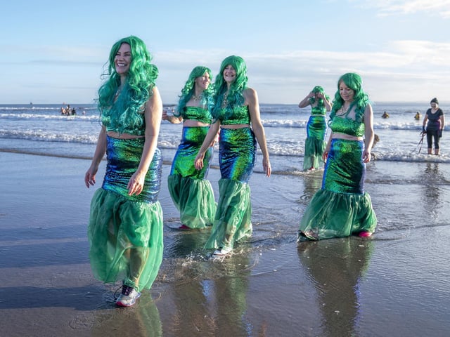 People take part in a Loony Dook New Year's Day dip in the Firth of Forth at Kinghorn in Fife.