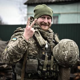 A Ukrainian soldier gives a V-for-Victory sign not far from the frontline with Vladimir Putin's forces near Kyiv (Picture: Aris Messinis/AFP via Getty Images)