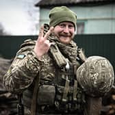 A Ukrainian soldier gives a V-for-Victory sign not far from the frontline with Vladimir Putin's forces near Kyiv (Picture: Aris Messinis/AFP via Getty Images)