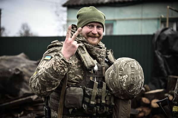 A Ukrainian soldier gives a V-for-Victory sign not far from the frontline with Vladimir Putin's forces near Kyiv (Picture: Aris Messinis/AFP via Getty Images)