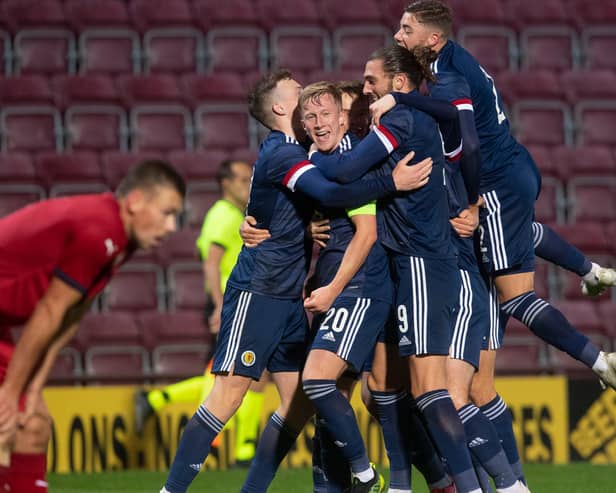 The Scotland players celebrate Ross McCrorie's goal to make it 2-0.