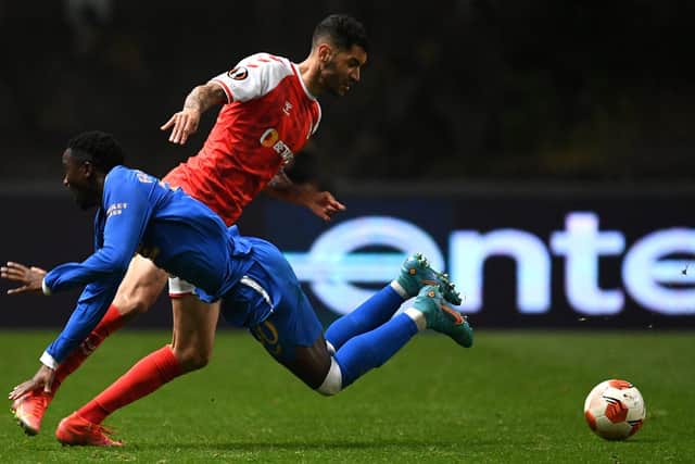Vator Tormena of Sporting Braga is challanged by Fashion Sakala of Rangers.