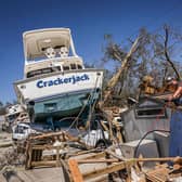 People clear debris in the aftermath of Hurricane Ian in Fort Myers Beach, Florida. Picture: Giogio Viera/AFP via Getty Images