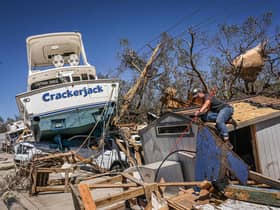 People clear debris in the aftermath of Hurricane Ian in Fort Myers Beach, Florida. Picture: Giogio Viera/AFP via Getty Images