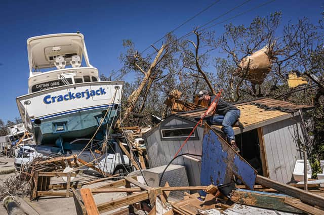 People clear debris in the aftermath of Hurricane Ian in Fort Myers Beach, Florida. Picture: Giogio Viera/AFP via Getty Images