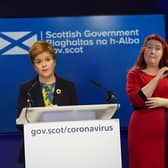 Nicola Sturgeon in front of the ditched inverted Saltire logo.