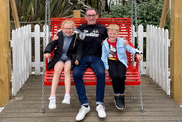 Swing out sister and brother Ella and Harry Trembath, aged eight and five, with granddad Chris "PP" Page