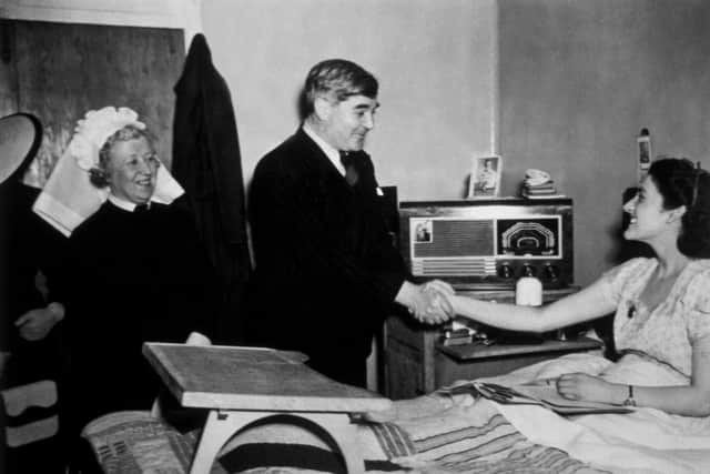 Labour health minister Aneurin Bevan is seen meeting a patient in 1948, the year the NHS was created (Picture: Edward G Malindine/Getty Images)