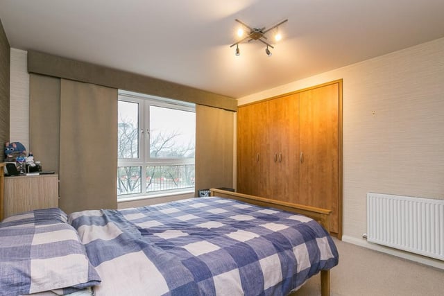 The spacious master bedroom includes a large built-in wardrobe, and TV and phone points.