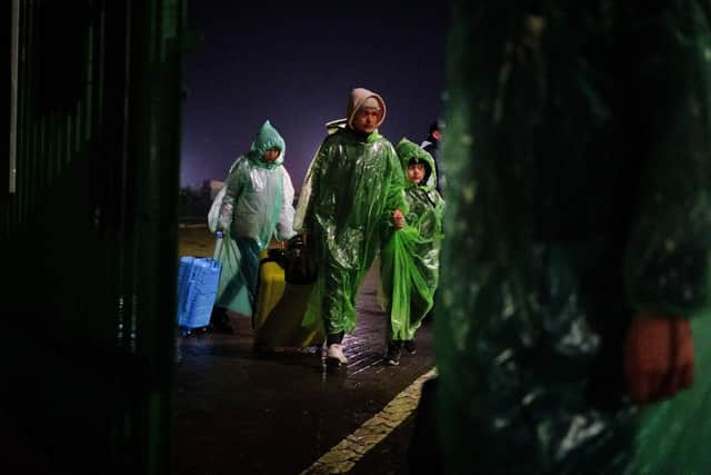 A family of Ukrainian refugees crosses the border point from Ukraine into Medyka, Poland