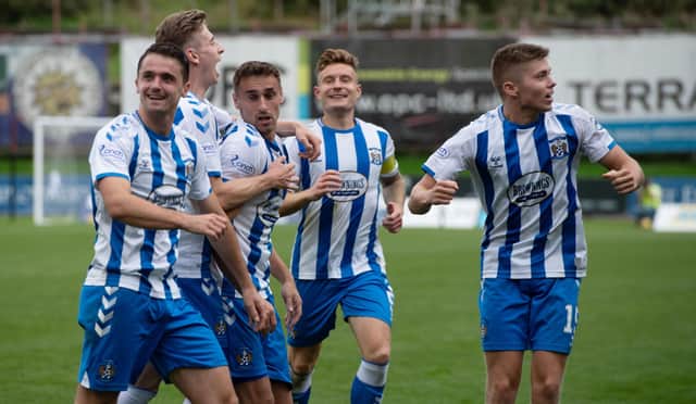 Kilmarnock's players celebrate after Kevin Holt's own goal gives them the lead. (Photo by Sammy Turner / SNS Group)