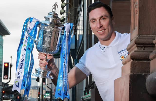 Former Celtic captain Scott Brown holds up the Scottish Gas Scottish Cup. Pic: Steve Welsh