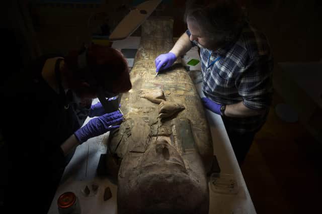Conservators at Perth Museum and Gallery cleaning the 3000 old mummy Ta-Kr-Hb.