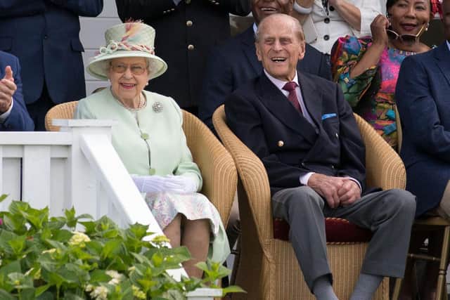 Queen Elizabeth II and the Duke of Edinburgh watch a British Driving Society parade during the Bentley Motors Royal Windsor Cup Final at Guards Polo Club, Windsor Great Park, Egham, Berkshire.