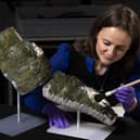 Undated handout photo issued by National Museums Scotland of conservator Bethan Bryan with an "incredibly rare" piece of Roman armour from the second century which has been reconstructed from dozens of fragments. Photo: Duncan McGlynn/National Museums Scotland/PA Wire