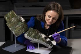 Undated handout photo issued by National Museums Scotland of conservator Bethan Bryan with an "incredibly rare" piece of Roman armour from the second century which has been reconstructed from dozens of fragments. Photo: Duncan McGlynn/National Museums Scotland/PA Wire