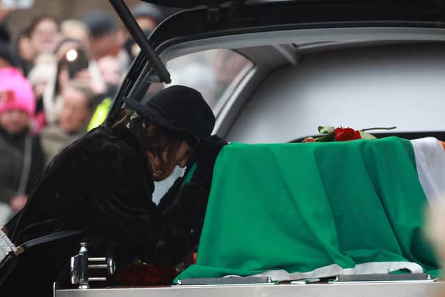 Victoria Mary Clarke, wife of Shane MacGowan, pays respects to his coffin as it arrives for the funeral of Shane MacGowan at Saint Mary's of the Rosary Church, Nenagh, Co. Tipperary. Picture: Niall Carson/PA Wire