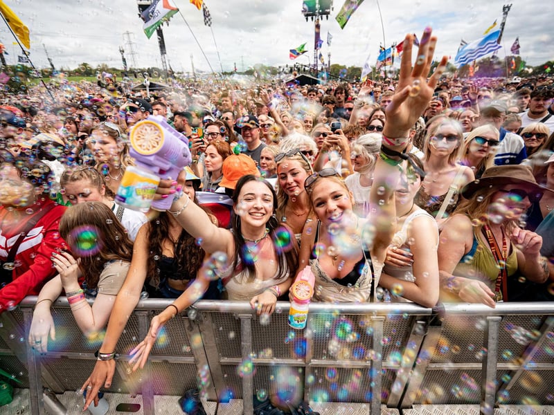 Music fans blow bubbles as they watch ferstival acts