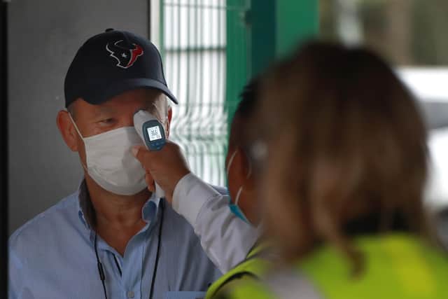 England coach Eddie Jones has his temperature taken before a match. Picture: David Rogers/Getty Images