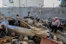 People in Rafah, Gaza, inspect damage caused to their homes following Israeli air strikes, on Wednesday. Whilst a new ceasefire deal is negotiated between Israel and Hamas, there are mounting concerns over an IDF ground invasion of Gaza's southern city of Rafah where some 1.4 million internally displaced Palestinians are sheltering, and the UN warns of a "large scale" loss of life.