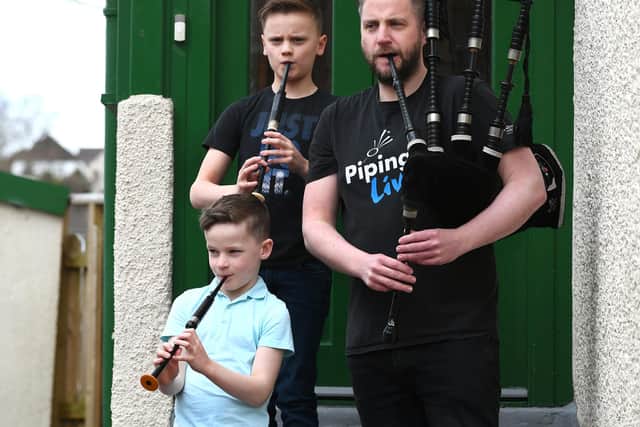 Finlay MacDonald, newly appointed director of the National Piping Centre, practises for the Pipe Up for Key Workers tribute with sons Elliott (10) and Fionn (8) on chanter