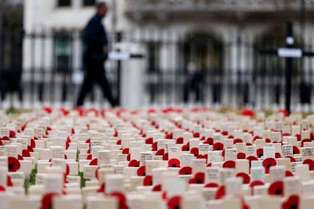 Rows of crosses with poppies are laid out to make a field of Remembrance beside Westminster Abbey. Picture: Tolga Akmen/AFP via Getty Images